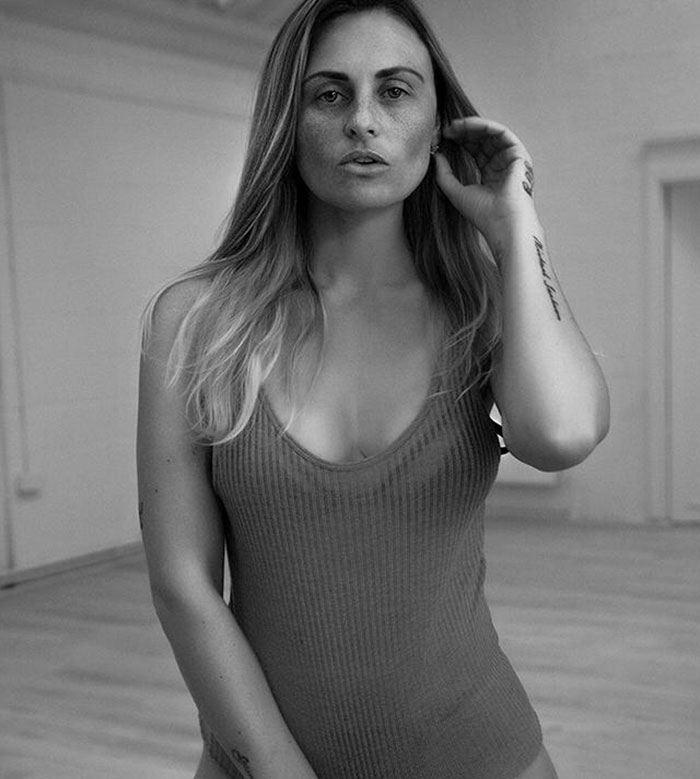 Woman with long hair and tattoos in a sleeveless top, illustrating Britain's most hated woman with harrowing diagnosis.