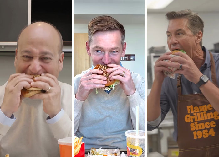 Three men eating burgers indoors, highlighting Wendy's joining the burger battle after McDonald's CEO's viral moment.