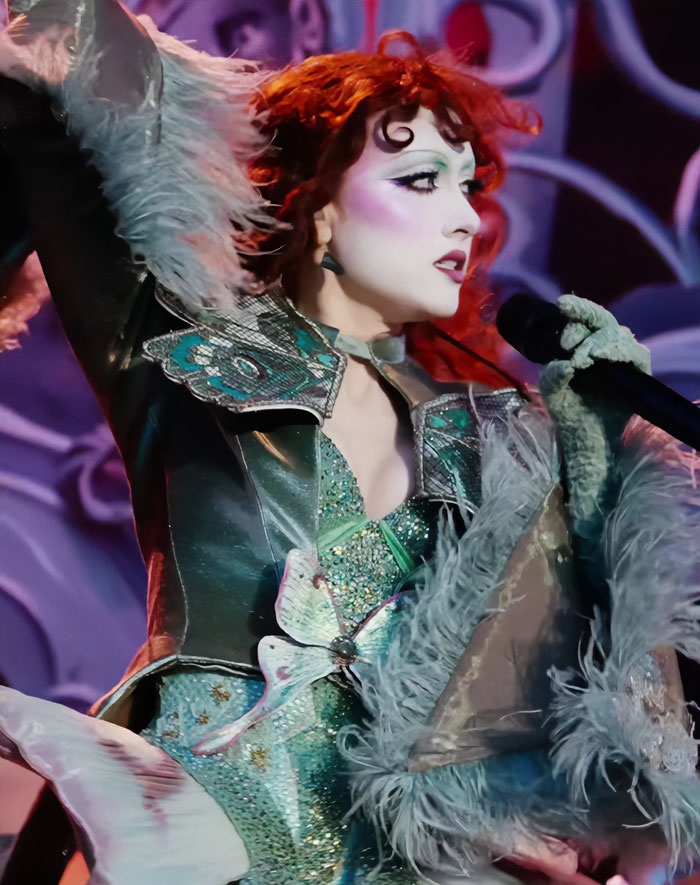 Chappell Roan performing on stage in elaborate costume, fans furious after security guard identity revealed controversy. Chappell Roan performing on stage in elaborate costume, fans furious after security guard identity revealed controversy.