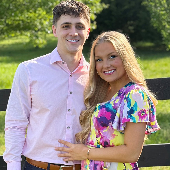 Young couple outdoors smiling, featuring cheerleader Laken Snelling, highlighting Snapchat history about her newborn&rsquo;s passing.