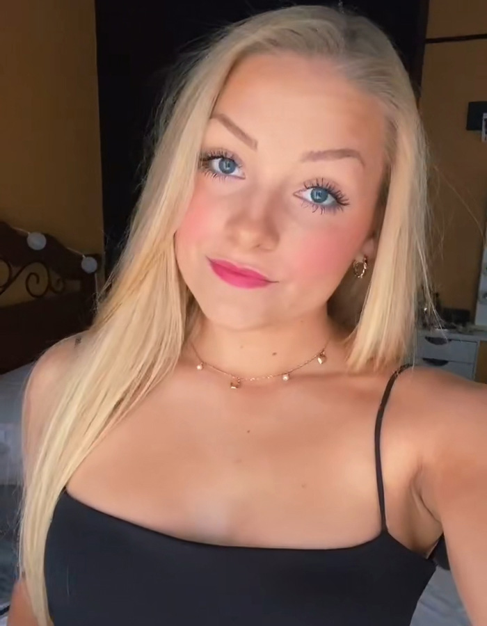 Cheerleader Laken Snelling with blonde hair and blue eyes wearing a black top, revealing details about her newborn&rsquo;s passing.