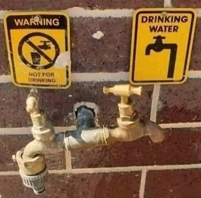Two outdoor water faucets with conflicting yellow warning signs, one says not for drinking, the other drinking water.