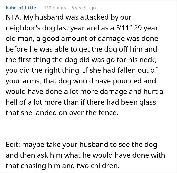 Wife holding twin girls near fence while being chased by dog in a backyard during a tense moment.