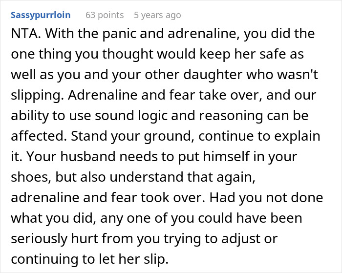 Wife with twin girls near a fence being chased by a dog in a lively outdoor setting on a sunny day