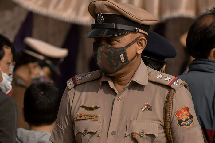 Police officer in uniform and mask, representing industries linked to businesses that are usually more corrupt than known.