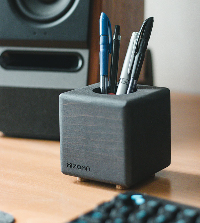 Pen holder on desk with pens and markers, representing office revenge on coworkers who deserved it.