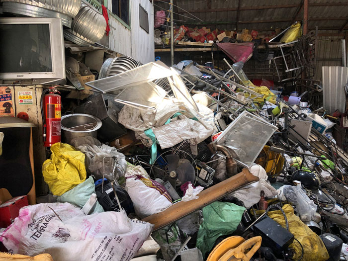 Cluttered home filled with trash and discarded items, reflecting a landfill-like environment linked to mom and pregnant daughter.