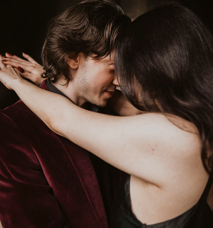 A couple leaning close in an intimate moment, illustrating stories of catching exes cheating through their Spotify activity.