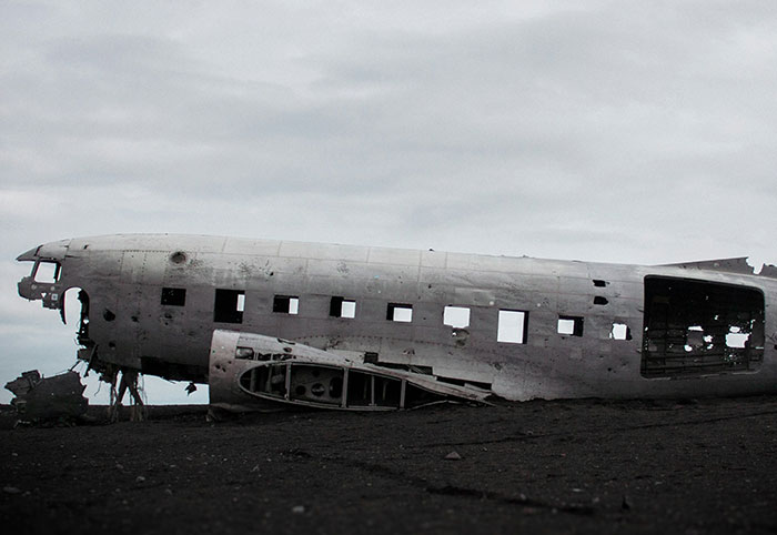 Wreckage of an abandoned plane on a desolate beach, evoking creepy facts about the ocean depths and mysteries.