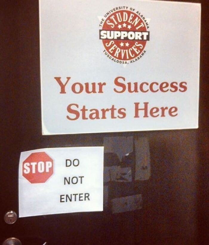 Conflicting door signs showing success starts here and stop do not enter, creating a weird and cringey photo moment.