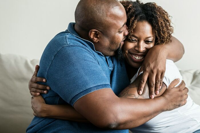Couple embracing and smiling warmly, symbolizing forgiveness and healing after cheating spouse challenges.