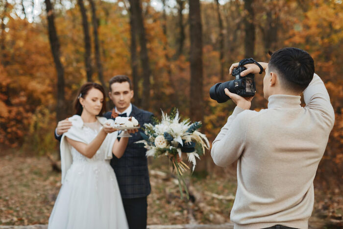Photographer capturing a bride and groom outdoors, symbolizing dark industry secrets quietly hiding behind the facade.