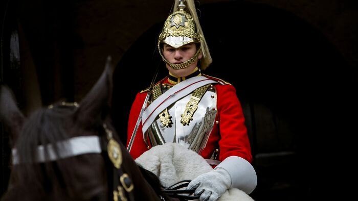 Guard in traditional uniform on horseback at iconic landmark, illustrating popular myths about landmarks around the world.