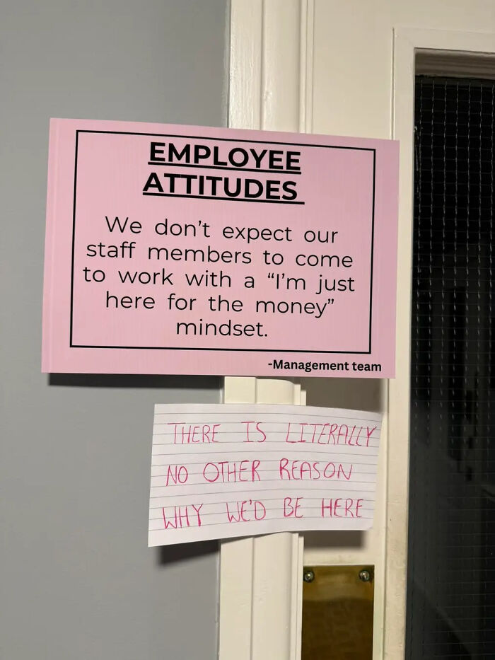 Pink sign about employee attitudes stating staff should not have a money-only work mindset, with a handwritten note disagreeing below.