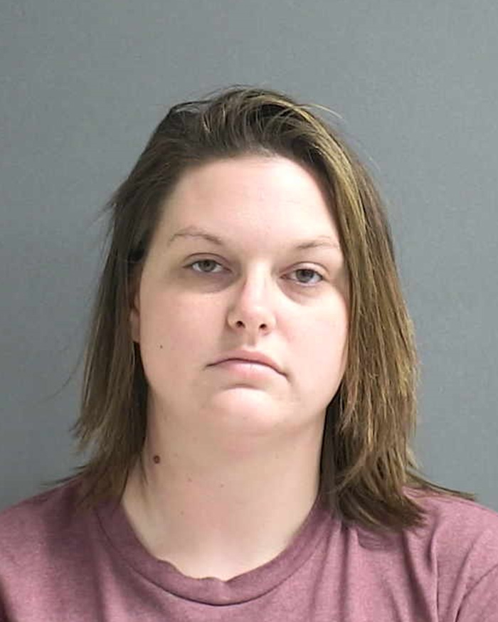 Mugshot of a woman accused of allowing boyfriend to harm young son, resulting in 46 injuries, facing legal consequences.