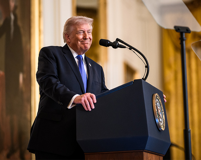 Former President Trump at a podium speaking about doctors weighing in on Trump&rsquo;s neck rash and likely causes.