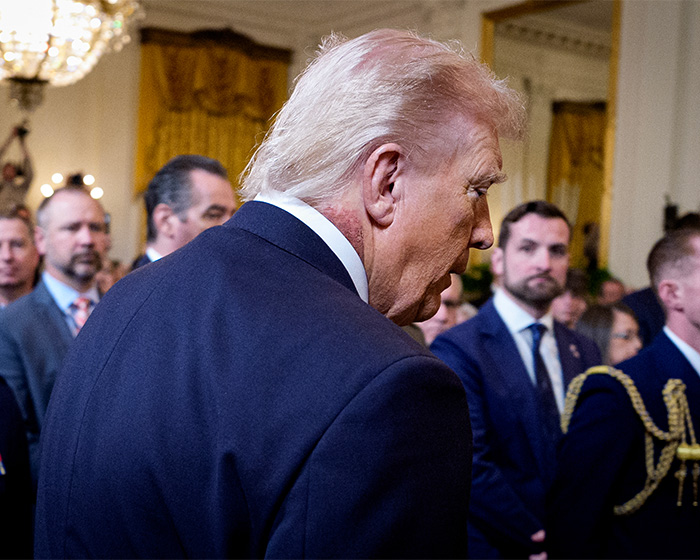 Former President Trump seen from behind in a crowded room, doctors weigh in on Trump&rsquo;s neck rash and likely cause.