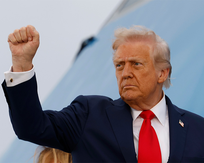 Former President Trump raising his fist, with doctors weighing in on his neck rash and its likely cause.