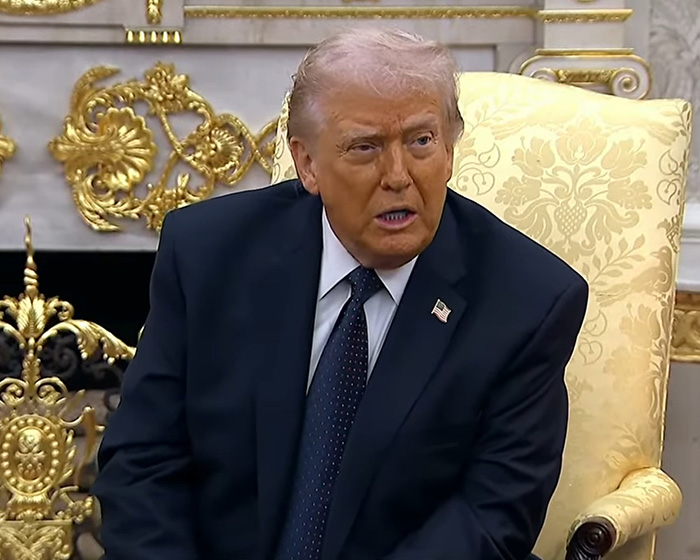 Donald Trump seated in a suit, with doctors weighing in on his neck rash and discussing likely causes.