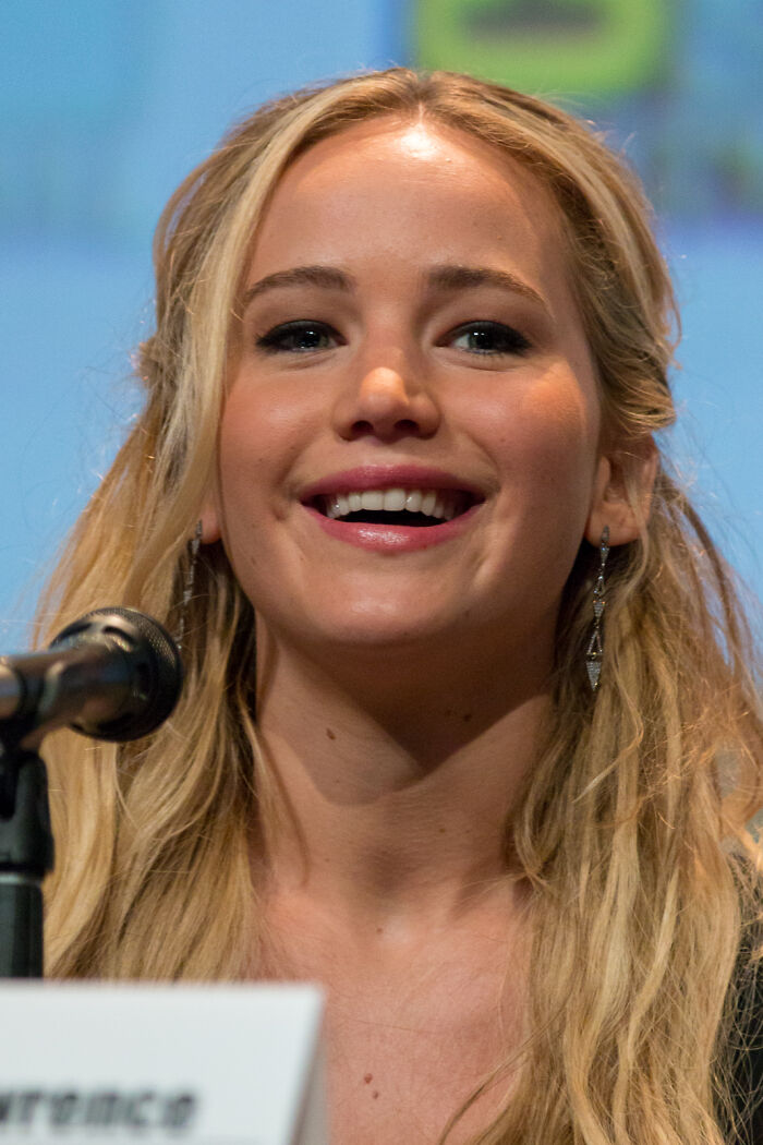 Close-up of a woman smiling at a microphone, representing custom 2.5 million mobile mansion celebrity lifestyle.