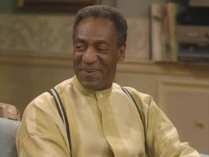 Man smiling warmly in a casual setting, illustrating people confessing which celebrities they used to like but now dislike.