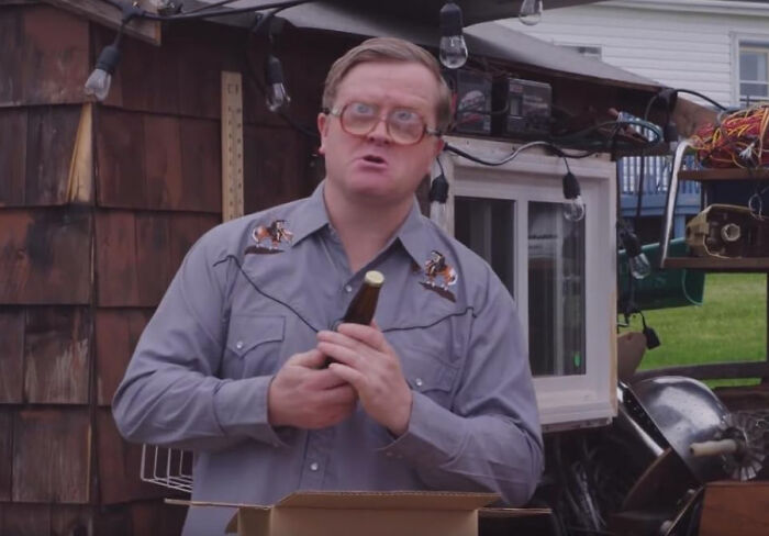 Man in glasses holding a bottle outdoors, illustrating people confessing which celebrities they used to like but now hate