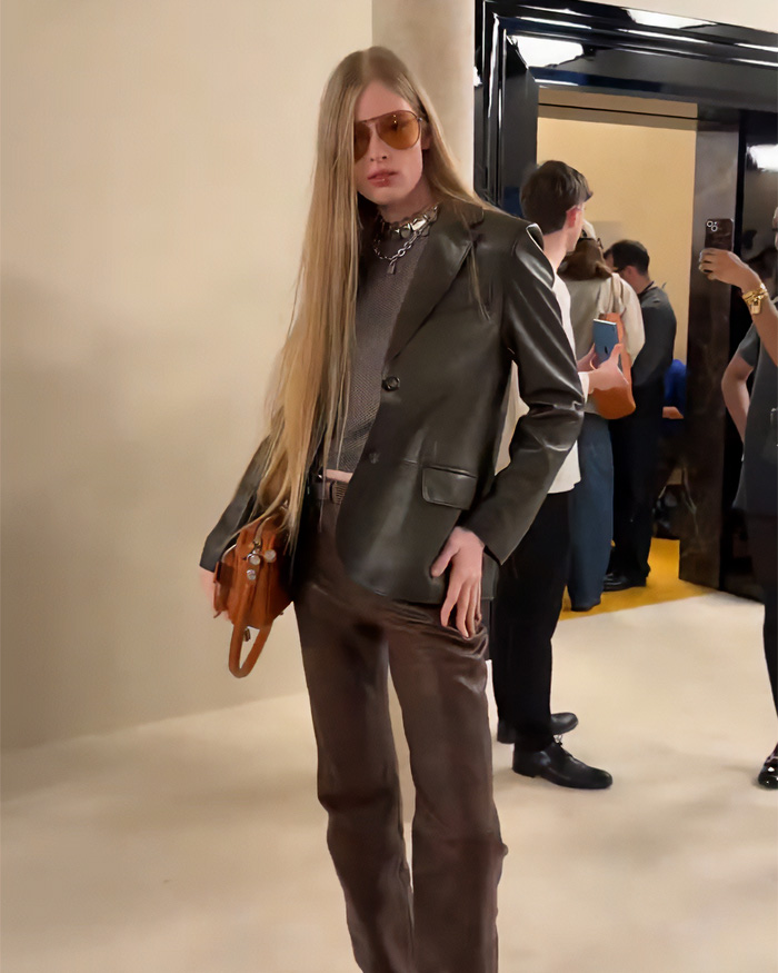 Elon Musk&rsquo;s estranged daughter posing in stylish leather outfit at Paris Fashion Week, sparking viral debate and media buzz.