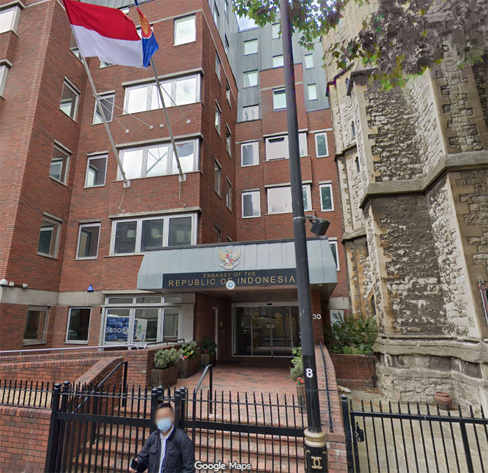 Embassy of the Republic of Indonesia in London with flags and a blurred person walking by, related to Bonnie Blue public stunt.