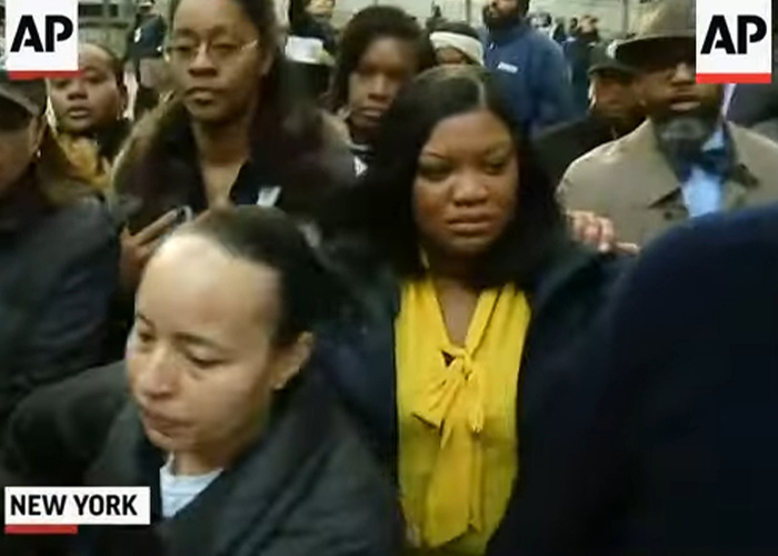 Crowd of people in New York appearing concerned, related to Epstein prison guard Googling name before passing incident.