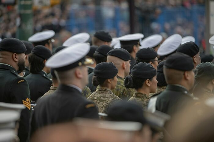 A diverse group of American military personnel in uniform attending a formal event demonstrating real American scenes.