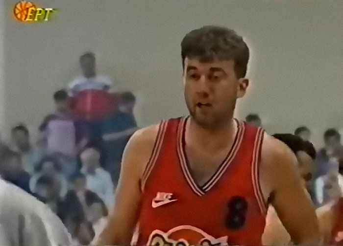 Basketball player wearing red jersey with number 8 in a crowded indoor gym, illustrating personal hell and ruined lives.