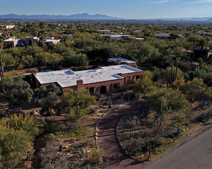 Aerial view of a desert home surrounded by vegetation, linked to FBI analysis in Nancy Guthrie case investigations.