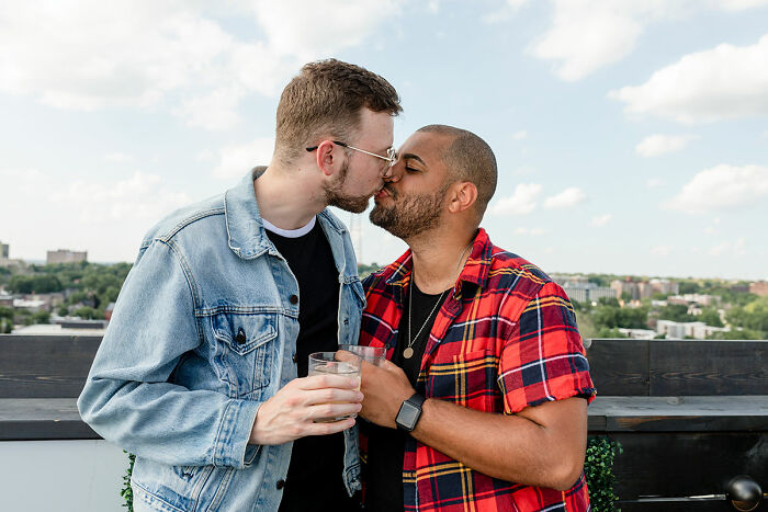 Two men sharing a tender kiss on a rooftop, symbolizing change and overcoming incel loneliness.