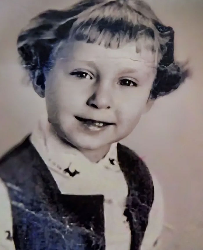 Childhood photo of a young child with a hair disaster featuring uneven bangs and styled in pigtails.