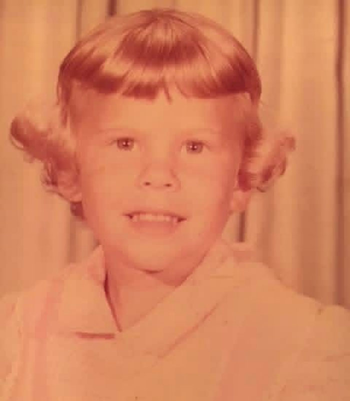 Childhood photo of a young child with a vintage hairstyle showing a classic hair disaster from the past.