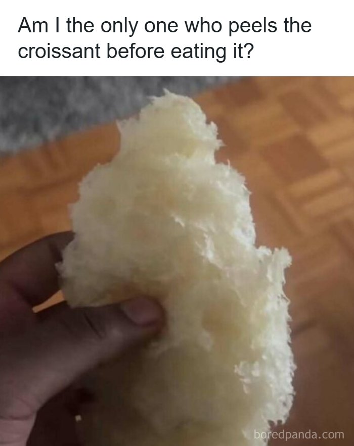 Hand holding peeled croissant layers, illustrating a food lover meme about unique eating habits.