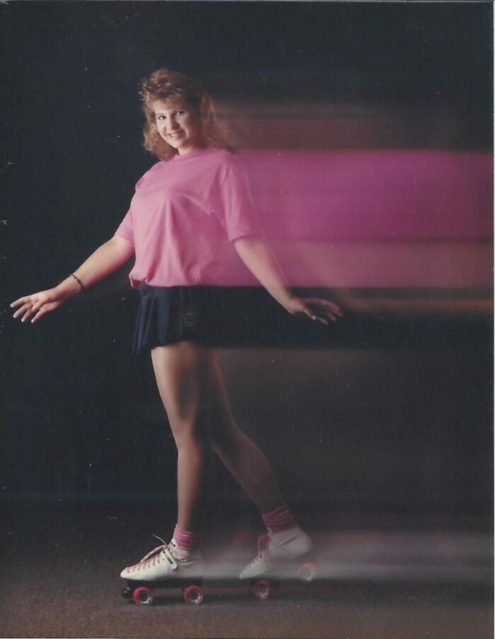Teen girl on roller skates with motion blur effect, a funny school picture day fail capturing movement unpredictably.