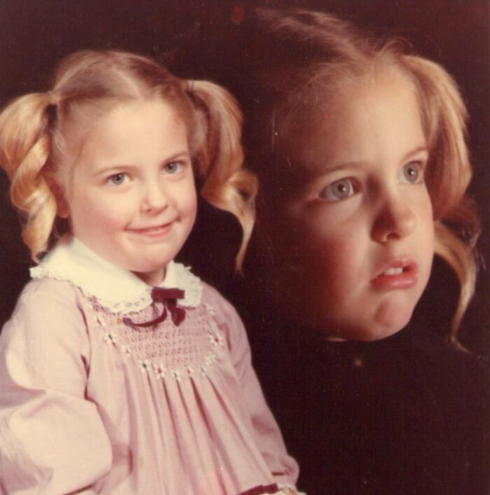 Vintage school picture with a girl in pigtails and a smocked dress, a classic example of funny school picture day fails.