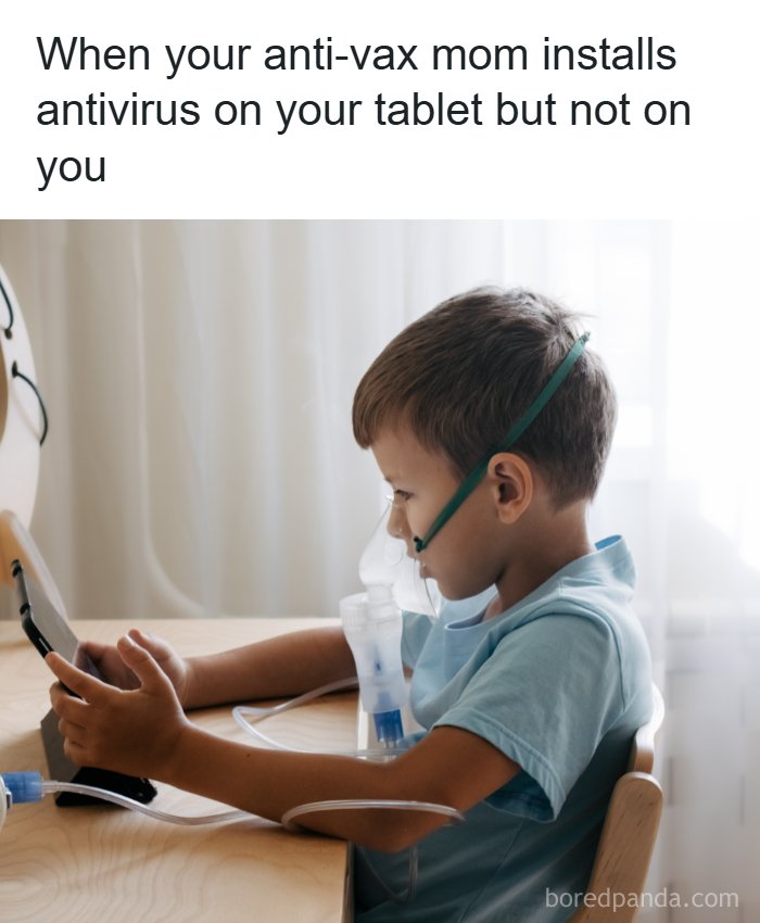 Young boy using a tablet while wearing a medical oxygen mask, representing memes for doctors or patients tired of it all.
