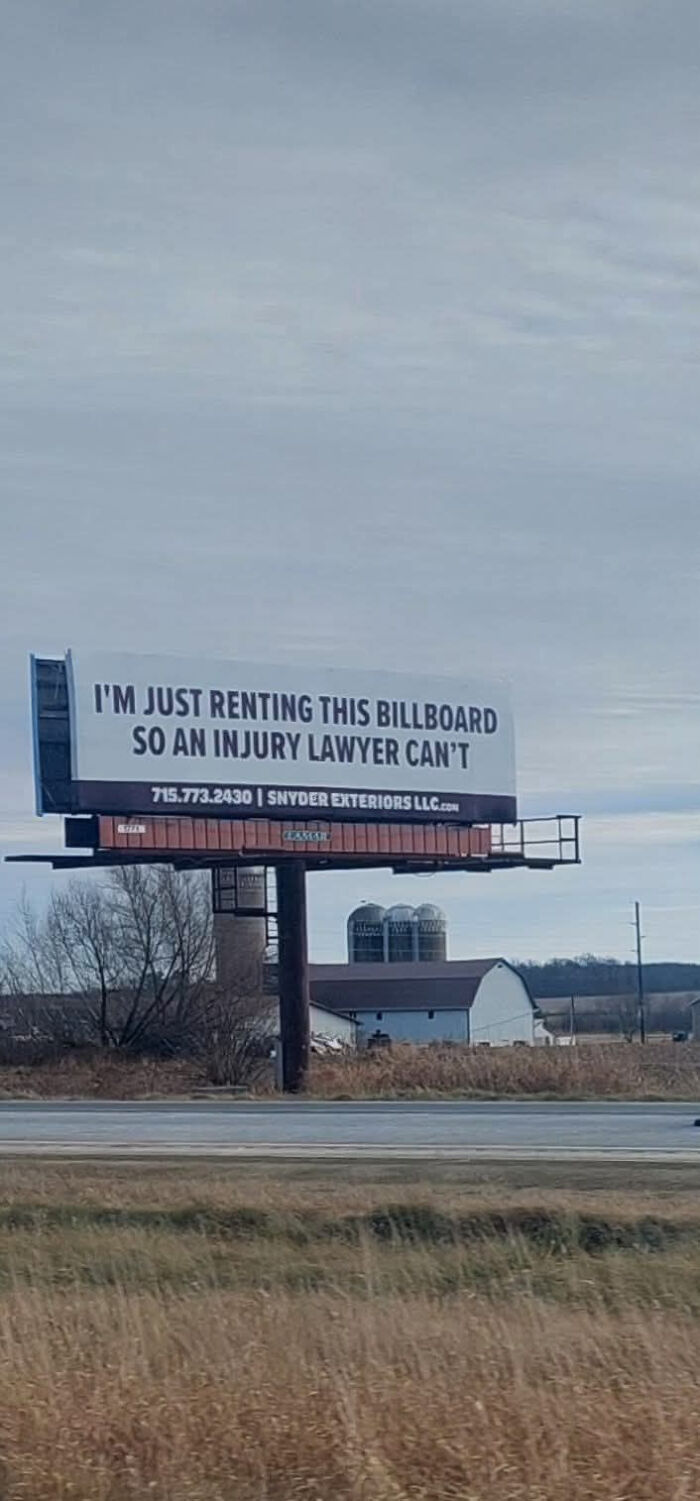 Humorous roadside sign rented to keep injury lawyers from advertising, capturing funny signs that make people laugh or do a double take.