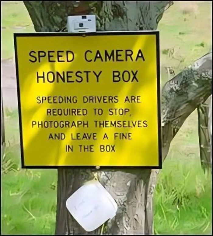 Yellow sign with speed camera honesty box instructions, making people laugh or do a double take on roadside humor.