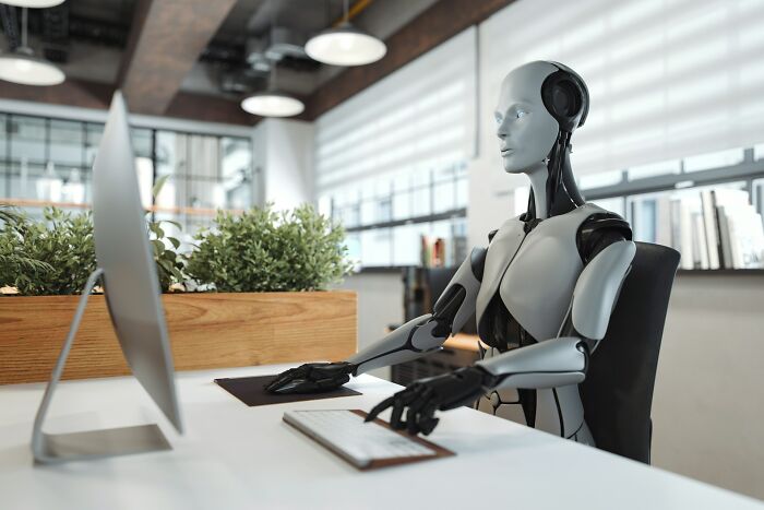 Futuristic robot working on a computer in a modern office, symbolizing the changing perspectives as the older you get.