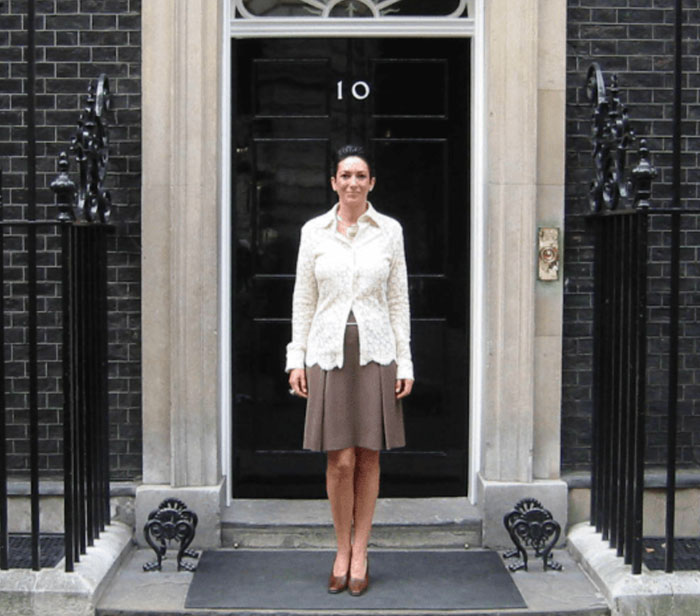 Ghislaine Maxwell standing in front of a black door at 10 Downing Street, related to prison job reactions.