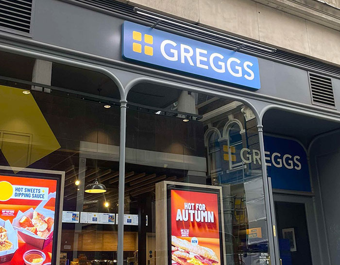 Greggs storefront with promotional signs, unrelated to King Henry VIII portrait time travel claim controversy.