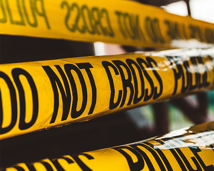 Yellow police tape marking a grisly scene in downtown LA where a man lost his life after removing his own package.