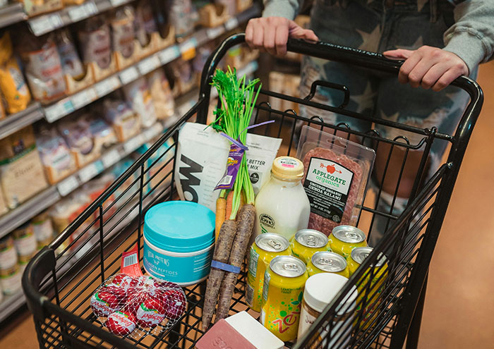 Shopping cart filled with groceries illustrating seemingly harmless things partners do that still drive some people insane.