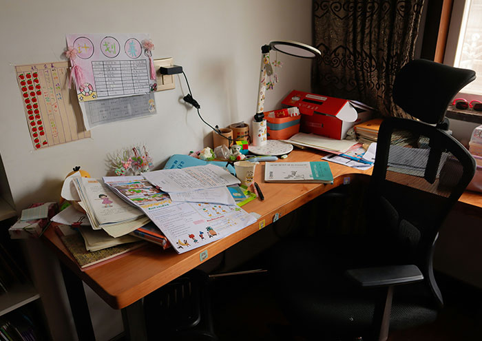 Cluttered desk with papers, books, and office supplies, illustrating seemingly harmless habits partners do that drive others insane.