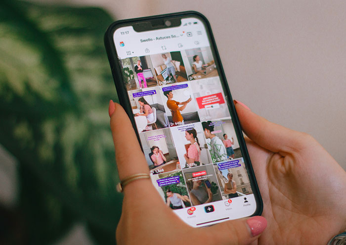 Person holding smartphone browsing content related to partners and things that drive people insane.