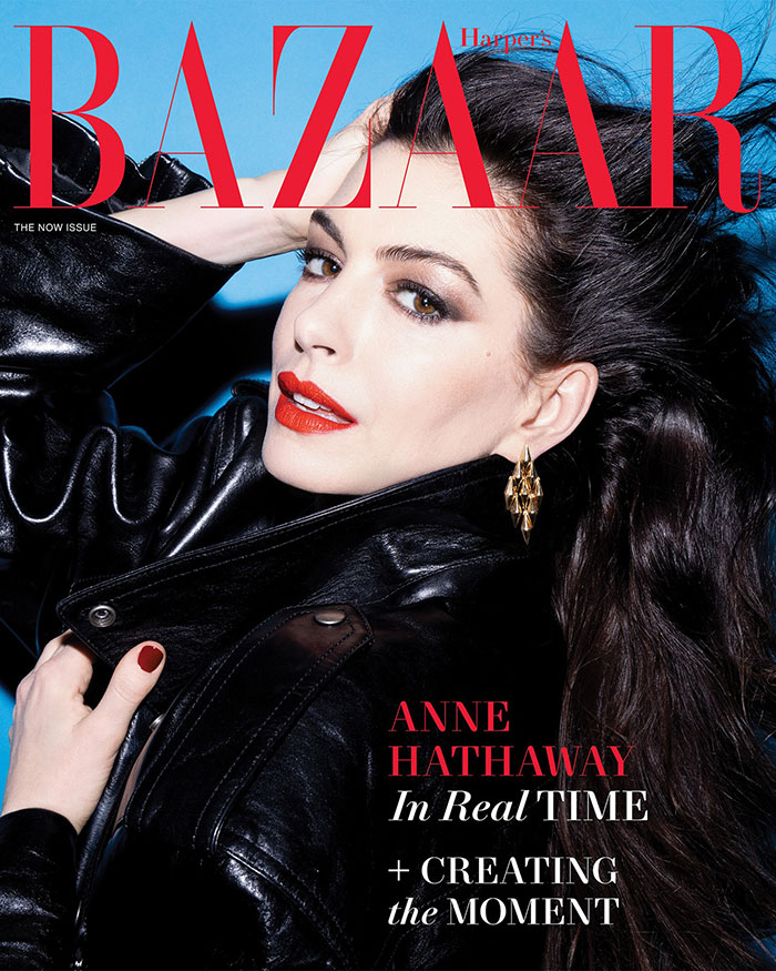 Anne Hathaway posing in a black leather jacket with bold red lipstick, highlighting Oscars appearance discussion.