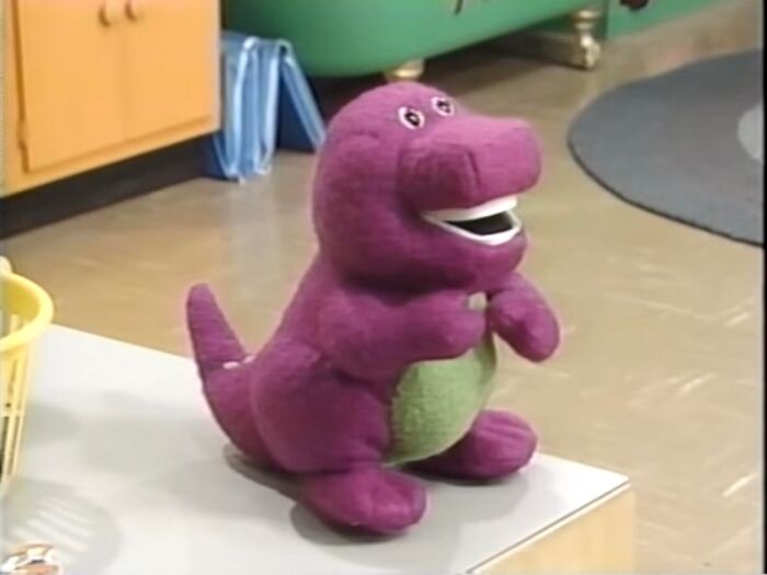Purple dinosaur toy sitting on a countertop in a room, unrelated to terrifying moments in urban exploration.